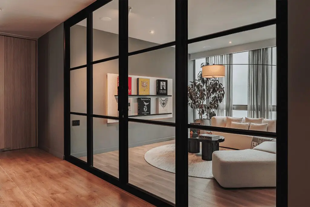 La sensación de resguardo de esta sala se logró a partir de la iluminación y un gran sofá La sensación de resguardo de esta sala se logró a partir de la iluminación y un gran sofá