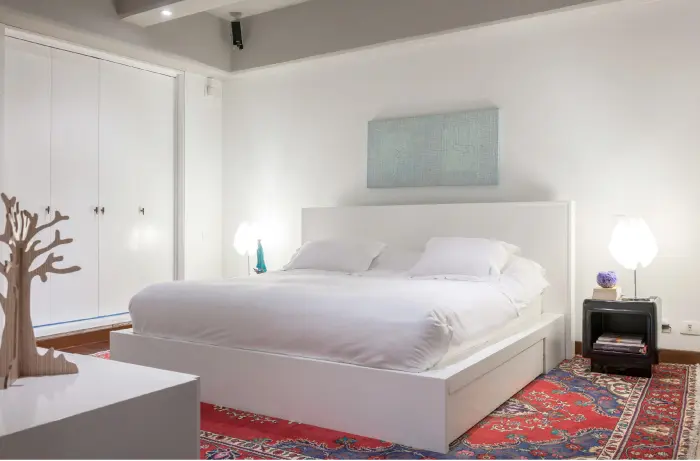 El tapete persa cobra protagonismo dentro de la limpieza estética de la habitación principal, cuya sencillez se ajusta para el descanso. El cuadro de fondo es del artista indígena Kindi Jatsu. Las mesas de noche son acrílicas y fueron encontradas en 5 en Punto.