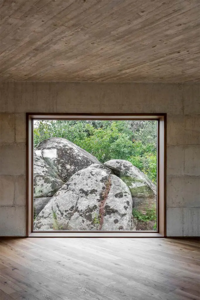 Una casa entre rocas y robles en españa, con una arquitectura cruda y atemporal