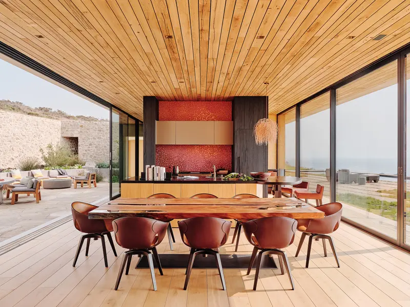 Press kit | 2757-26 - press release | modern sustainability in big sur - studio schicketanz - residential architecture -  the "kauri" dining table by rea 1920 and "ginger" dining chairs by poltrona frau sit center stage within the dining room, flanked by ocean views to the west and the interior courtyard to the east. - photo credit: joe fletcher photography