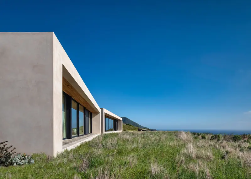 Press kit | 2757-26 - press release | modern sustainability in big sur - studio schicketanz - residential architecture -    the residence consists of four separate “cubes,” separating living and sleeping quarters. The primary three cubes on the western side are comprised of floor-to-ceiling glazed sliders, serving as the western walls, which take maximum advantage of the expansive views of the pacific ocean, as well as allow for strong connections to the pool. The fourth cube, the guest suite, faces the hills and courtyard. - photo credit: tim griffith photography