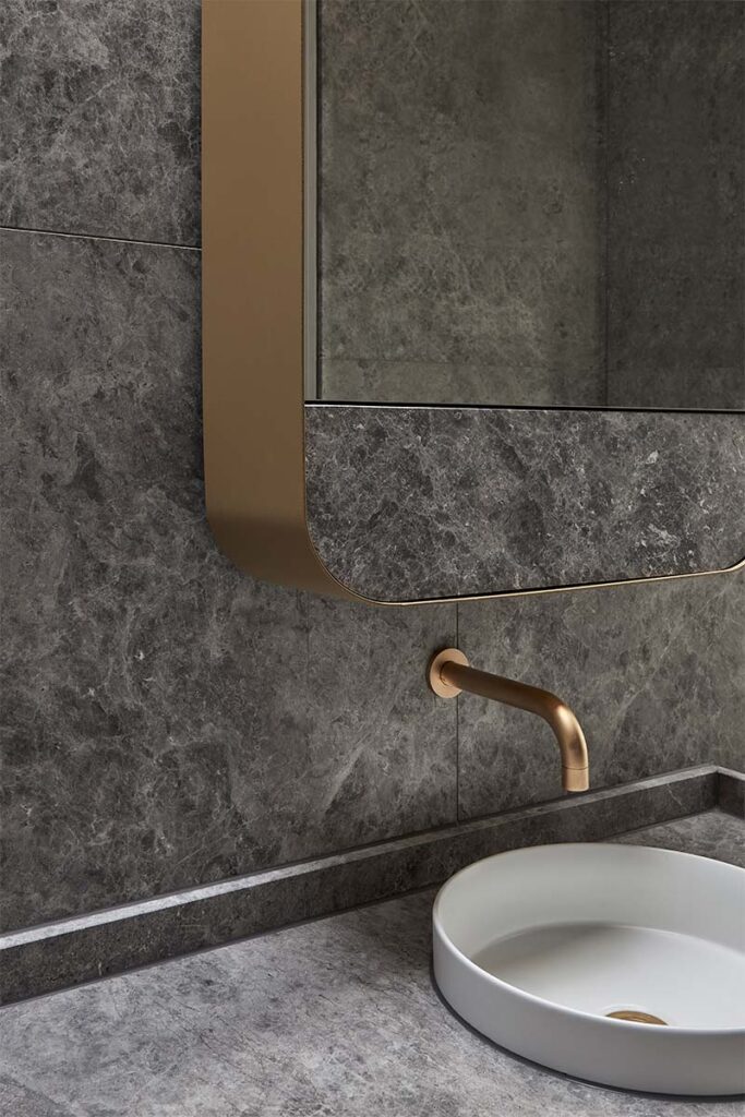 El mármol negro define el lenguaje arquitectónico de este baño